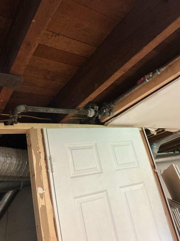 Relocated copper water supply piping and shut off valve to accommodate installation of new stud wall in basement area. Provided estimate for work prior to completion, then successfully repositioned plumbing components to allow for framing modifications while maintaining proper water supply functionality and access to shutoff valve.
