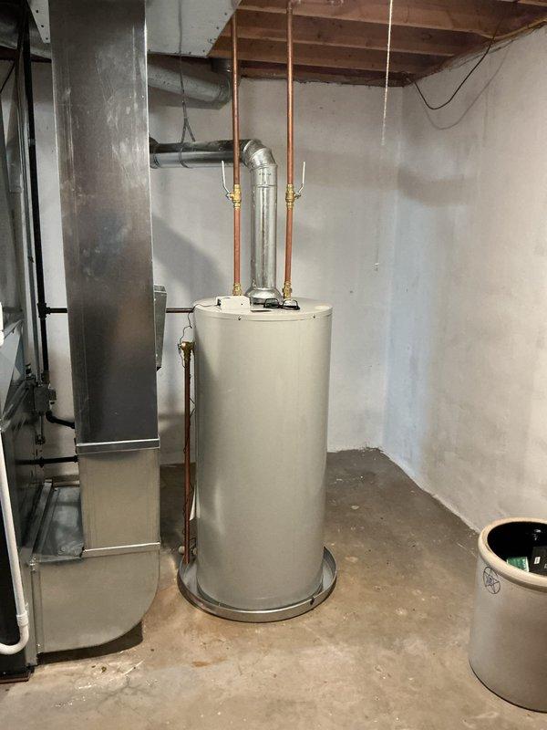Completed installation of 40-gallon natural gas water heater in residential basement utility area. Installed new Bradford White unit with proper copper supply line connections, pressure relief valve, and gas line hookup, ensuring all plumbing and gas connections meet code requirements. Unit tested and verified operational with no leaks detected.