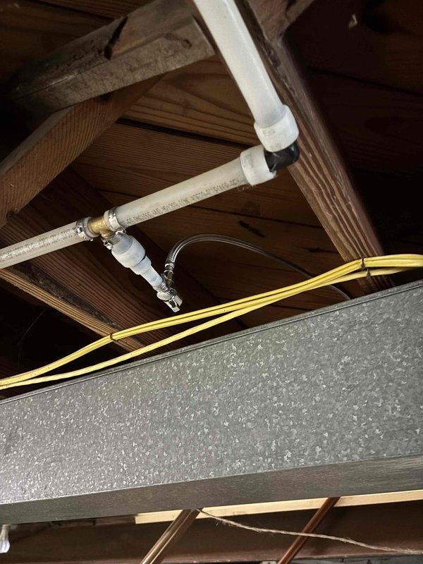 Installed ice maker water supply line for refrigerator. Ran 1/4" copper tubing from existing water supply through attic space, securing line to ceiling joists with appropriate clamps. Connected supply line to refrigerator ice maker inlet valve using compression fittings. Verified proper water flow and checked all connections for leaks. Installation complete and operational.