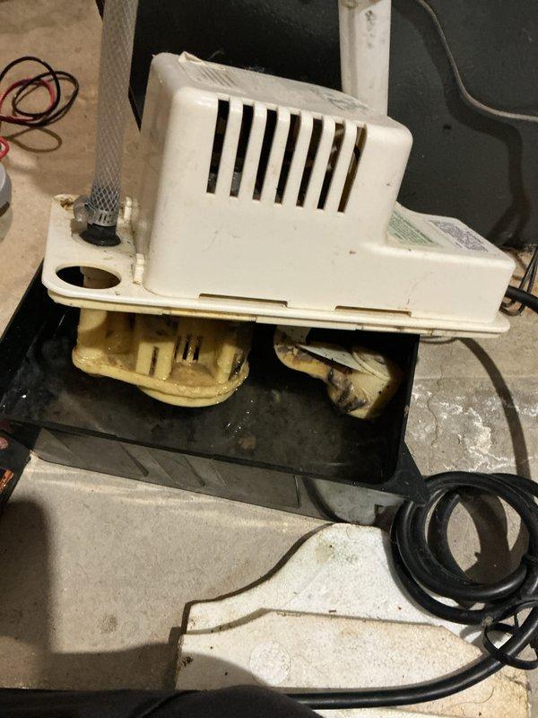Completed annual heating and cooling maintenance on EnergiAir system including air conditioning tune-up, furnace inspection, and humidifier service under 5-year club membership plan. Inspected condensate pump system showing mineral deposits and water staining on unit and mounting platform, verified proper operation and drainage. All equipment operational with no immediate concerns noted.