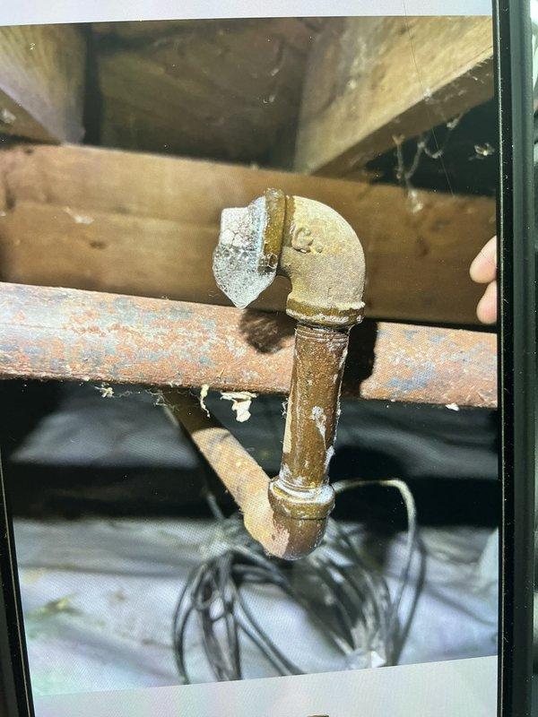 Returned to property to perform combustion analysis on heating system and contacted technical support for consultation. Documented existing plumbing infrastructure showing advanced corrosion on copper piping and brass fittings in crawl space area, with horizontal pipe section displaying significant oxidation and surface deterioration requiring attention.