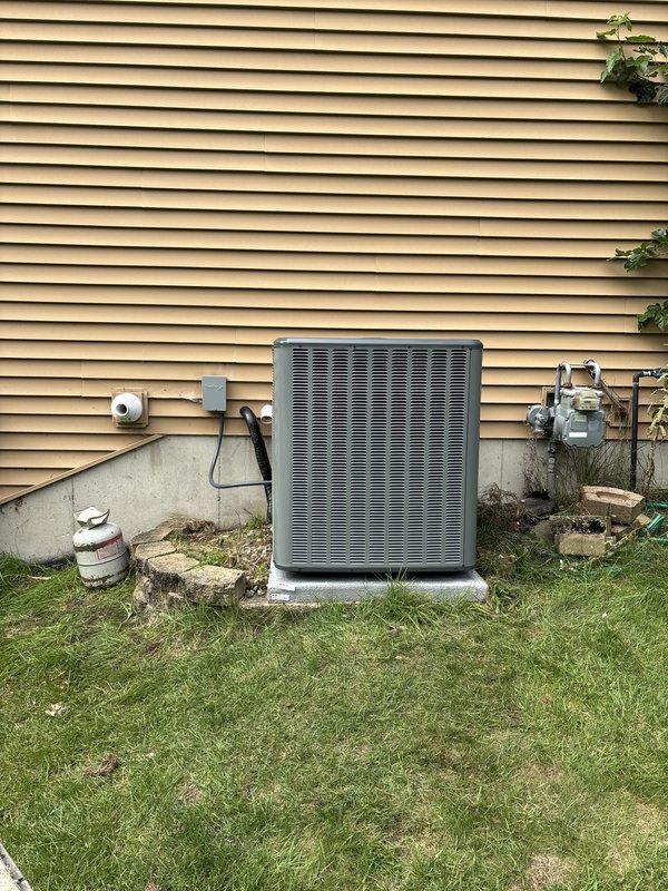 Completed full HVAC system installation including new furnace and air conditioning condenser unit. Installed outdoor AC condenser on concrete pad with proper clearances from building exterior and utility connections. Interior installation included new air handler/furnace unit in basement mechanical room with proper venting and PVC condensate drainage. All equipment properly connected to existing gas line, electrical service, and ductwork. System tested and verified operational upon completion.