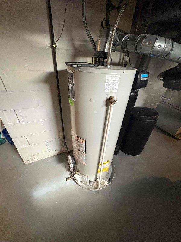 Responded to customer complaint of banging noises from tank-style water heater in basement of single-family residence. Performed complete water heater tune-up service including full tank flush to remove sediment buildup, which was the source of the reported noise. Inspected all plumbing connections, supply lines, and venting components for proper operation and safety. Unit operational and functioning quietly upon completion of service.
