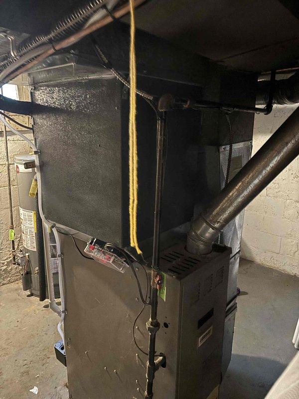 Completed full air conditioning system replacement including outdoor condensing unit and indoor air handler components. Installed new condenser unit on existing concrete pad with proper refrigerant line connections and electrical hookup to exterior disconnect. Connected system to existing furnace infrastructure in basement mechanical room, ensuring proper integration with ductwork and establishing all necessary refrigerant lines, condensate drainage, and control wiring between indoor and outdoor units.