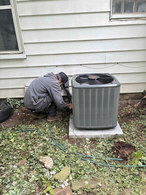 Completed full air conditioning system replacement including outdoor condensing unit and indoor air handler components. Installed new condenser unit on existing concrete pad with proper refrigerant line connections and electrical hookup to exterior disconnect. Connected system to existing furnace infrastructure in basement mechanical room, ensuring proper integration with ductwork and establishing all necessary refrigerant lines, condensate drainage, and control wiring between indoor and outdoor units.