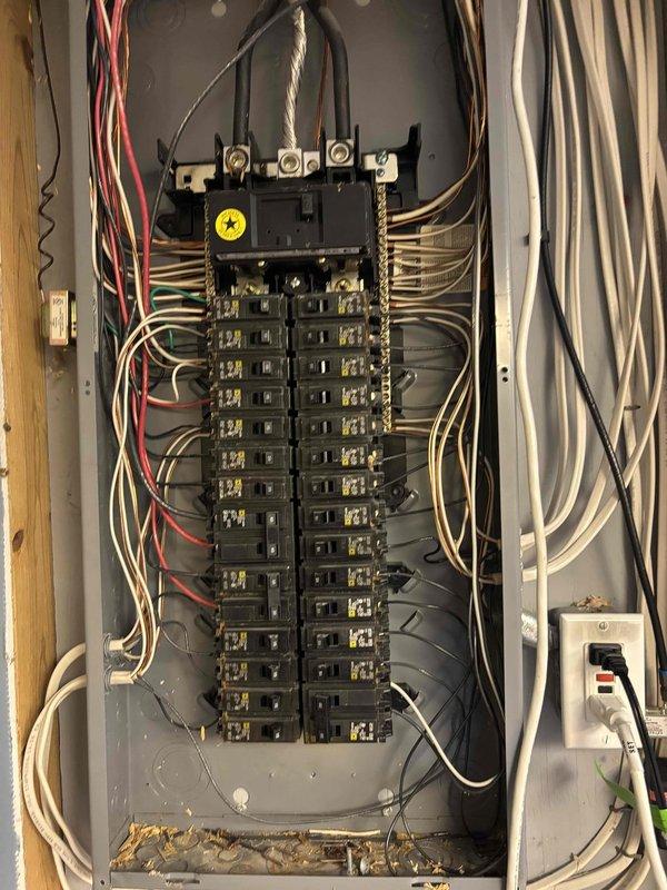 Responded to service call for oven circuit breaker repeatedly tripping. Upon arrival, inspected main electrical panel and identified significant debris accumulation and evidence of overheating on the main bus bar and terminal connections. Found contamination affecting breaker connections and potential arcing damage in the panel interior. Documented existing conditions with photographs showing compromised electrical components and safety concerns. Panel exhibited signs of thermal stress with discolored materials and burnt residue on terminal areas. Recommended immediate panel evaluation and potential replacement due to safety hazards present in the electrical distribution system.