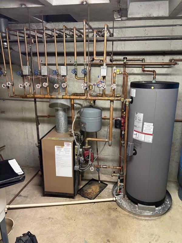 Responded to no-heat call on 39-year-old Slant Fin boiler with red indicator light illuminated. Upon arrival, performed diagnostic testing of the hydronic heating system and electrical components using clamp meter, which indicated power supply issues. Inspected boiler control board, circulator pumps, and associated zone valves on the copper manifold distribution system. Identified failed control component causing system lockout. Replaced defective part, reset boiler controls, verified proper amp draw, and confirmed system returned to normal operation with all zones functioning correctly.