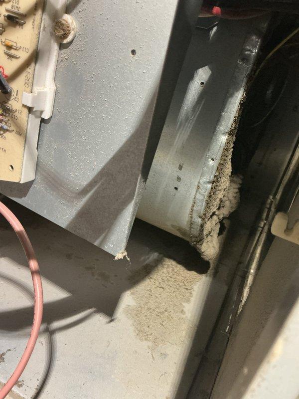 Completed annual heating and cooling maintenance on a 27-year-old Payne furnace and 5-year-old ENE air conditioning system. Performed comprehensive tune-up on both units, including inspection of all major components, electrical connections, and operational controls. Accessed unit through interior housing, noting accumulated dust and debris along bottom edges and metal channels consistent with normal operational wear. Inspected blower assembly, heat exchanger compartments, and insulation panels. Verified proper function of red electrical wiring connections and secured mounting brackets. System tested and confirmed operational following maintenance procedures.