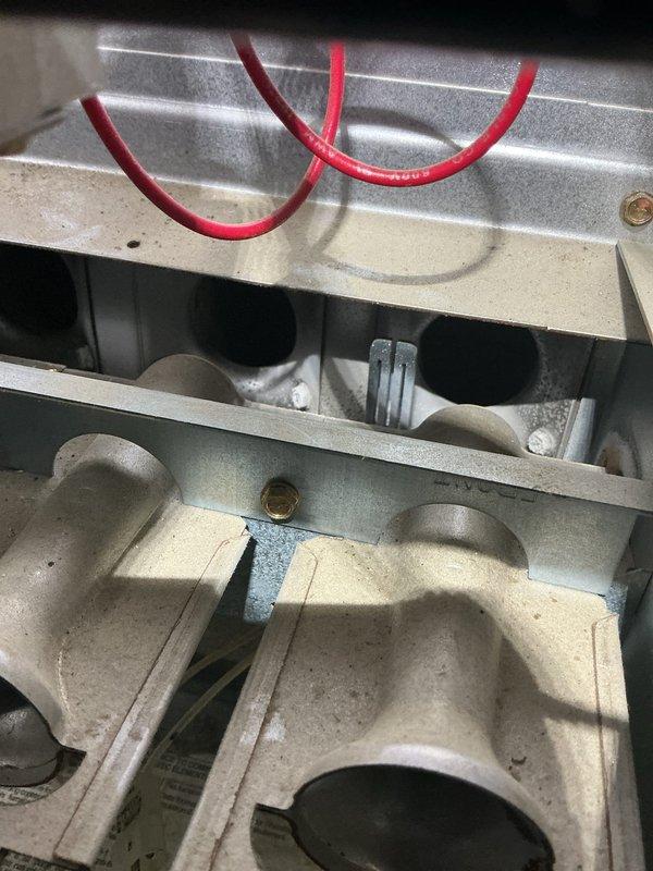 Completed annual heating and cooling maintenance on a 27-year-old Payne furnace and 5-year-old ENE air conditioning system. Performed comprehensive tune-up on both units, including inspection of all major components, electrical connections, and operational controls. Accessed unit through interior housing, noting accumulated dust and debris along bottom edges and metal channels consistent with normal operational wear. Inspected blower assembly, heat exchanger compartments, and insulation panels. Verified proper function of red electrical wiring connections and secured mounting brackets. System tested and confirmed operational following maintenance procedures.