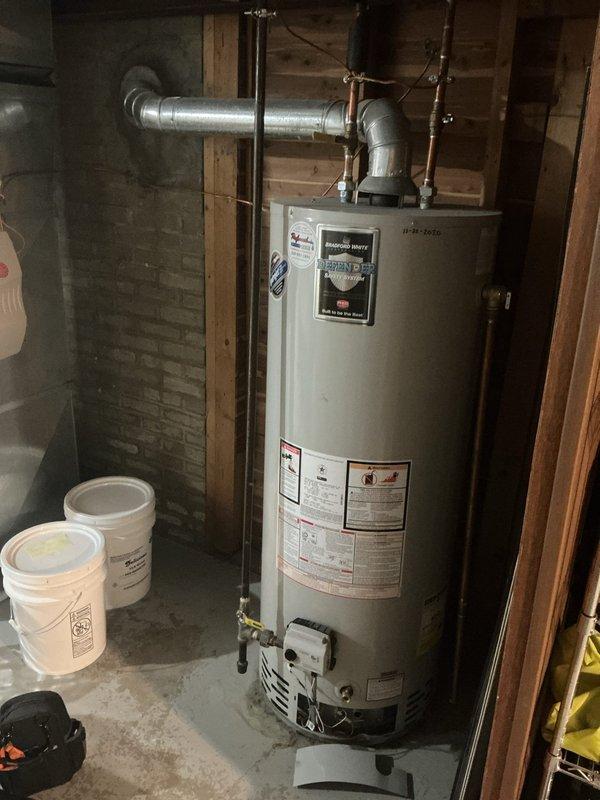 Responded to service call for water heater displaying faulty readings and low voltage issues. Upon inspection, examined internal electrical components and wiring connections at top of unit. Evaluated thermal sensors and control circuitry for proper operation and voltage readings. Assessed overall condition of aging water heater including gas burner assembly, plumbing connections, and venting system. Documented equipment condition showing signs of mineral deposits and general wear consistent with unit age. Verified all safety labels and specifications visible on exterior. Inspected copper piping, brass fittings, and gas line connections for integrity. Provided customer with diagnostic findings regarding electrical performance and recommendations for system maintenance.