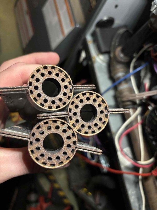 Completed annual heating maintenance on 6-year-old EnergiAir furnace with humidifier system under warranty through 01-2030. Performed comprehensive tune-up including inspection and cleaning of burner assemblies. Removed, inspected, and photographed three burner components showing normal operational wear patterns with heat discoloration around perforations. Verified proper combustion characteristics and burner function. Inspected electrical connections, wiring harnesses, and control systems. System tested and operating within manufacturer specifications.
