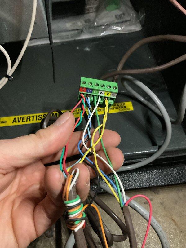 Completed annual heating tune-up on 2011 EnergiAir furnace model WT 11-2034. Performed standard maintenance inspection and verified all system operations. Inspected and documented thermostat wiring connections at terminal block, confirming proper wire terminations for R, C, G, W, and Y connections with appropriate wire nuts securing low-voltage control circuits. System operating within normal parameters with no humidity system present.