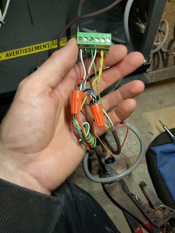 Completed annual heating tune-up on 2011 EnergiAir furnace model WT 11-2034. Performed standard maintenance inspection and verified all system operations. Inspected and documented thermostat wiring connections at terminal block, confirming proper wire terminations for R, C, G, W, and Y connections with appropriate wire nuts securing low-voltage control circuits. System operating within normal parameters with no humidity system present.