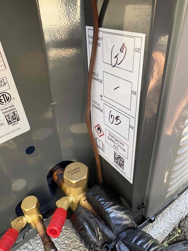 Completed full air conditioning system replacement. Removed existing outdoor condensing unit and installed new AC system with proper refrigerant charge verified and documented on equipment label. Connected brass service ports with protective caps installed on Schrader valves for future maintenance access. Interior air handler installed in basement mechanical room, integrated with existing Aprilaire whole-house humidifier and ductwork system. All refrigerant lines properly insulated and routed through cabinet. System tested for proper operation, airflow, and temperature differential across coil. All electrical connections verified and secured to manufacturer specifications.