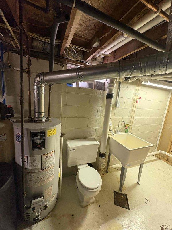 Provided estimate for replacement of existing Bradford White 40-gallon natural gas water heater (Model M1CD3S6FBN) located in basement utility area. Documented current installation including copper piping connections, clearance specifications, and proximity to existing HVAC ductwork and plumbing fixtures. Photographed equipment nameplate showing unit specifications including 40,000 BTU/hr input rating and reviewed replacement options with customer.