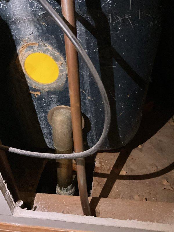 Responded to bathtub drain issue where the drain shoe elbow was broken following homeowner's attempt to replace overflow gasket. Upon inspection, assessed the existing brass waste and overflow assembly and discussed material options with customer, explaining the benefits and drawbacks of brass versus PVC systems. Brass offers superior durability and longevity but at higher material cost, while PVC provides adequate performance with easier installation and lower price point. Determined that full waste and overflow kit replacement was necessary due to compromised solder connection at drain shoe elbow that could not be reliably repaired. Documented existing plumbing configuration and mechanical systems in utility space for reference during replacement work.