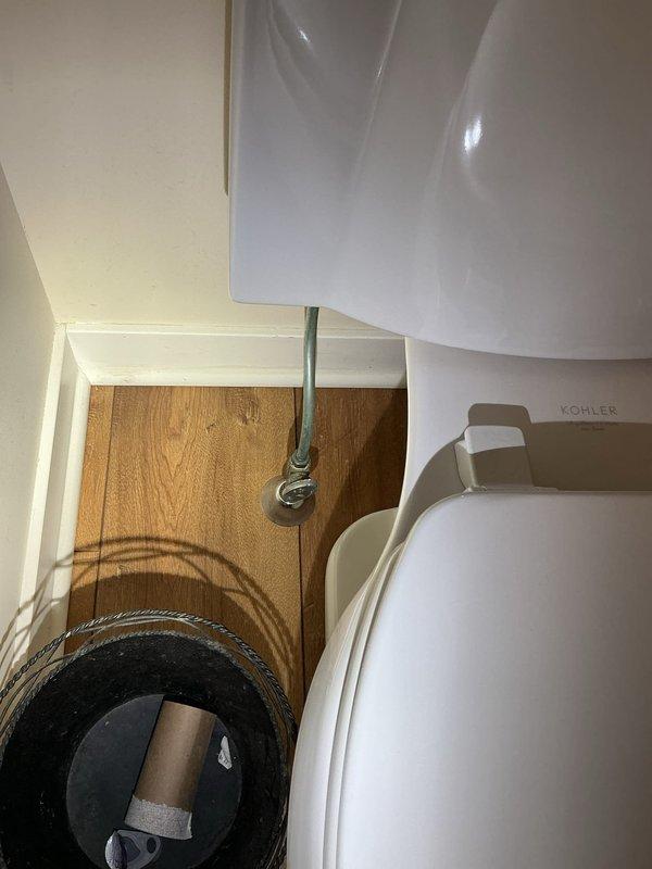 Responded to service call for constantly running toilet in small bathroom. Upon arrival, confirmed toilet was running continuously and water supply shutoff valve beneath the toilet would not fully close, preventing customer from stopping water flow. Inspected toilet tank components and identified faulty fill valve causing continuous water flow into tank and overflow tube. Removed tank lid and assessed flush valve assembly and flapper mechanism for additional wear. Replaced defective water supply shutoff valve beneath toilet with new quarter-turn angle stop valve to restore proper water control. Installed new fill valve assembly with refill tube to eliminate constant running condition. Tested all components for proper operation, verified shutoff valve functioned correctly, and confirmed no leaks at supply line connection or within tank. Left toilet in proper working order with no active water flow issues.