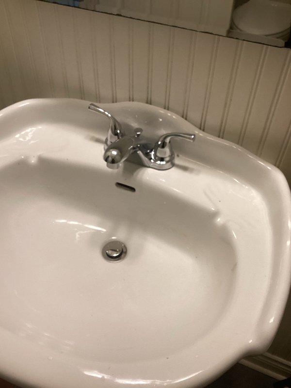 Responded to callback for sink repair reevaluation following previous estimate. Conducted thorough inspection of bathroom sink and faucet assembly. Assessed chrome two-handle faucet and porcelain basin for operational issues and potential repair requirements. Documented existing conditions with photographs for updated estimate preparation. Evaluated hardware components and plumbing connections to determine scope of necessary repairs versus previous assessment.
