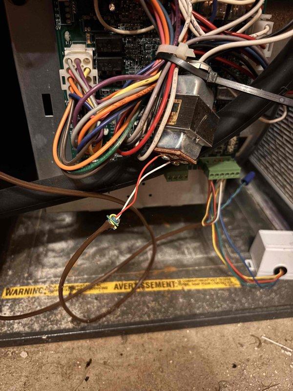 Completed annual heating maintenance on furnace system, treating as initial service visit per customer request. Performed comprehensive tune-up including inspection of all system components, burner assembly, heat exchanger, blower motor, and electrical connections. Discovered corroded flame sensor requiring replacement; removed old sensor showing significant buildup and oxidation, installed new sensor to ensure proper flame detection and system safety. Inspected control board wiring and connections, verified all wire terminations secure at terminal blocks. Documented system condition with photos of replaced component and control panel wiring configuration for service records.