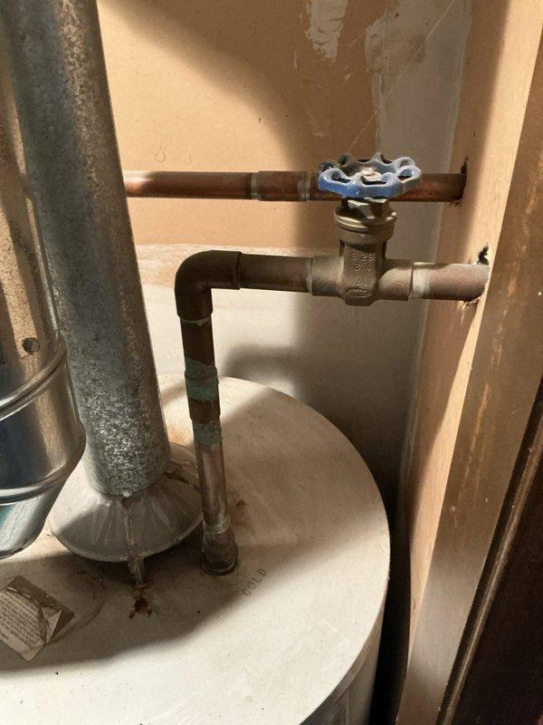 Conducted comprehensive assessment of existing HVAC system for furnace and air conditioning replacement estimate. Air conditioning unit has been non-operational for approximately two years. Evaluated current air handler installation in mechanical closet, noting equipment configuration with water heater in shared utility space. Documented existing ductwork connections, airflow pathways, and spatial constraints for equipment replacement planning. Assessed plumbing infrastructure including water shut-off valve assembly and piping configuration to determine compatibility requirements for new system installation. Photographed equipment layout, clearances, and utility connections to provide accurate replacement specifications and installation planning.