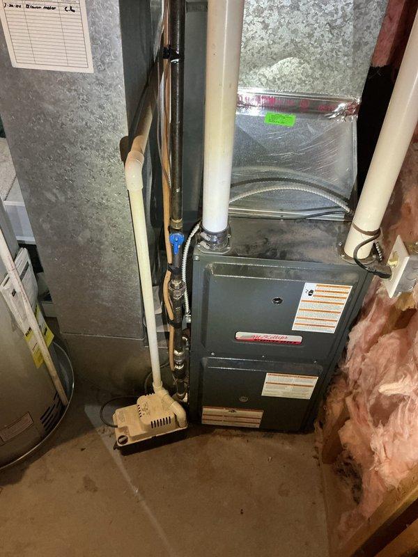 Completed estimate for air conditioning system in residential property. Documented existing HVAC equipment in basement utility room, including furnace unit, air handler, associated ductwork, and plumbing connections. Photographed current system configuration and mechanical room conditions to prepare comprehensive cooling system replacement proposal for tenant-occupied property.