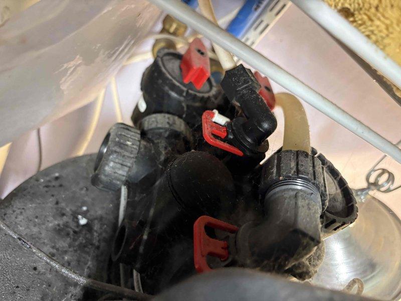 Conducted on-site assessment for tankless gas water heater replacement estimate. Existing 9-year-old HydroJet conventional storage water heater currently installed with standard plumbing connections, water treatment system, and electrical components. Documented current installation configuration including copper piping, shut-off valves, flexible connectors, and associated mechanical components to provide accurate specifications for tankless conversion requirements.