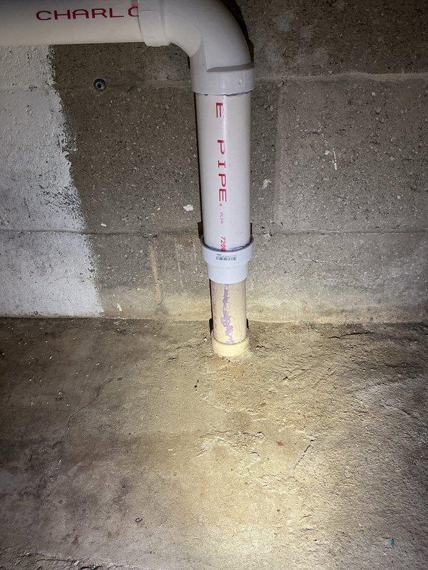Responded to washer drain backup issue. Upon inspection, found existing PVC drain line showing signs of age and deterioration with visible soiling along vertical run. Cleared obstruction from drain line and verified proper flow restoration. Tested system operation to ensure washer drainage functioning correctly without backup. System operational upon completion.
