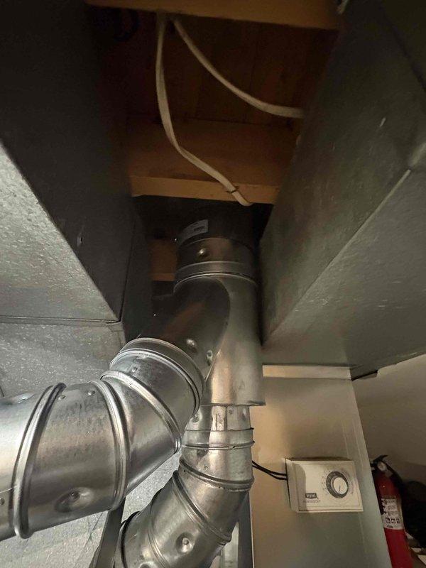 Completed full furnace installation in basement utility room, installing new Carrier brand heating unit with proper positioning and ventilation access. Installed and connected metallic ductwork system throughout the space, including vertical and horizontal runs with elbow joints and proper fastening to ensure efficient airflow distribution. System tested and verified operational with new air filter installed.