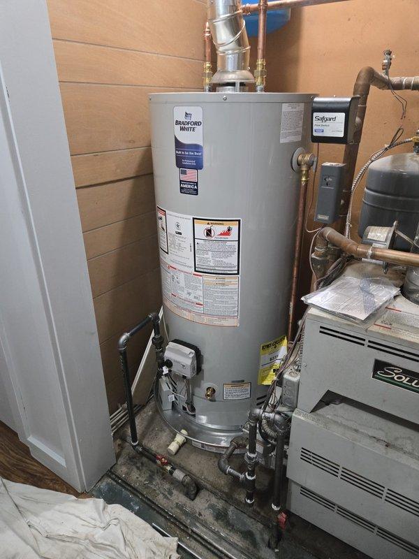 Successfully completed installation of a Bradford White 40-gallon natural gas water heater (Model RG24056N) in the mechanical room. Removed existing water heater and installed new unit with proper copper piping connections, brass fittings, and required safety valves. Connected gas supply line with appropriate pressure regulation per manufacturer specifications (40,000 BTU/hr input rating). Installed temperature and pressure relief valve, expansion tank connections, and verified all plumbing connections for leaks. Ensured proper venting and clearance requirements per installation guidelines. Tested unit operation, verified proper gas combustion, and confirmed water heating functionality. All work completed to code compliance and manufacturer specifications.