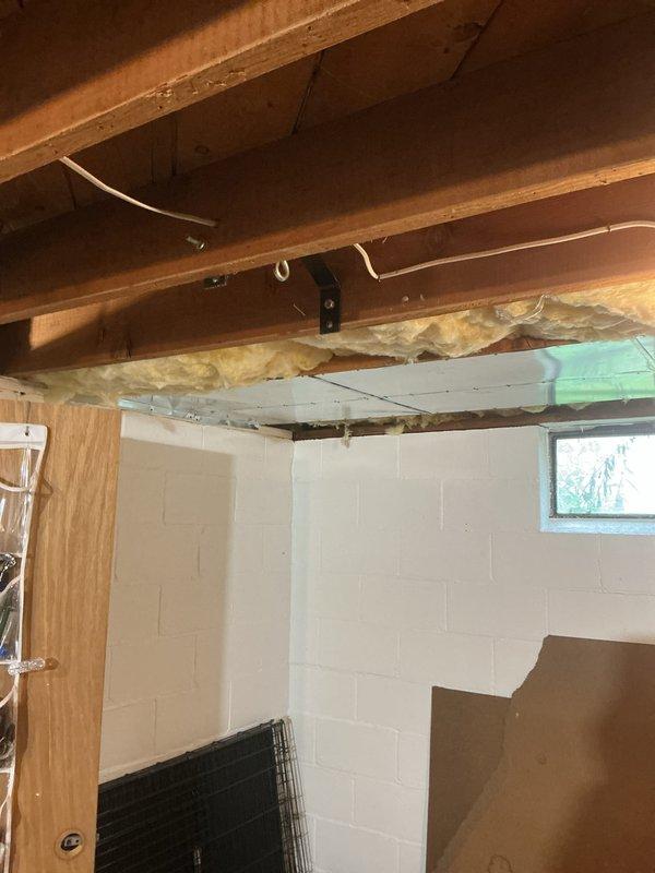 Completed full installation of Amana furnace and air conditioning system in residential basement. Unit was properly mounted on drip pan with PVC intake/exhaust venting installed vertically, ductwork connections secured, and electrical components wired according to specifications. System was tested and left operational with all safety labels and manufacturer documentation in place.