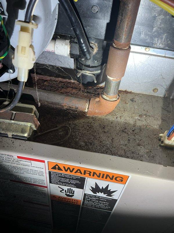 Completed annual heating and cooling maintenance on two systems: a 14-year-old Payne unit and a 31-year-old Lennox system. Performed comprehensive tune-up procedures including inspection of all mechanical components, electrical connections, and refrigerant lines. Observed oxidation on copper refrigerant piping with characteristic patina consistent with system age, along with corrosion and rust staining on mounting brackets and surrounding metal surfaces. Inspected capacitor and electrical connections, noting multiple wire terminations in good working order. Verified proper operation of both heating and cooling systems, checked safety labels and warning placards for visibility and compliance. Documented existing wear patterns and age-related deterioration typical of equipment service life. All systems operational upon completion of annual maintenance visit.
