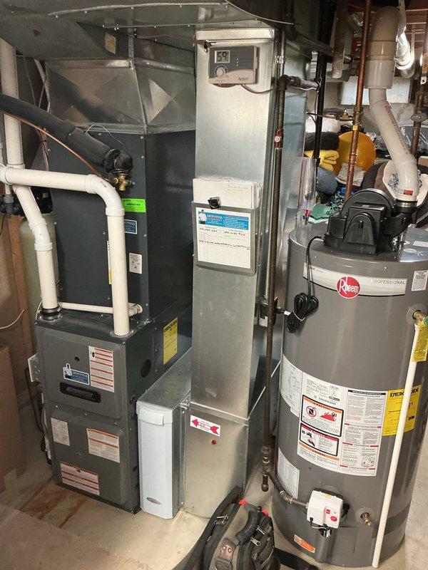 Completed comprehensive furnace tune-up on 6-year-old EnergiAir unit with warranty coverage through September 2029. Performed full system inspection including visual examination of control board, verified all electrical connections and terminals secure, tested safety controls and limit switches, inspected heat exchanger for cracks or deterioration, checked burner assembly and flame sensor operation, verified proper ignition sequence, measured temperature rise across heat exchanger within manufacturer specifications, inspected and cleaned blower assembly, checked motor amperage draw, verified adequate combustion air supply, inspected flue pipe and condensate drain system, tested thermostat operation and calibration, and confirmed all safety labels present. System operating properly with no deficiencies noted. Unit located in basement mechanical room alongside water heater. All components functioning within normal parameters.