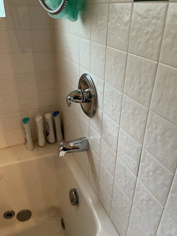 Responded to plumbing leak issue and performed diagnostic inspection of water supply system. Opened wall cavity to access copper piping, brass manifold assembly, and shutoff valves to identify source of leak. Technician to return for completion of repair work and wall restoration.