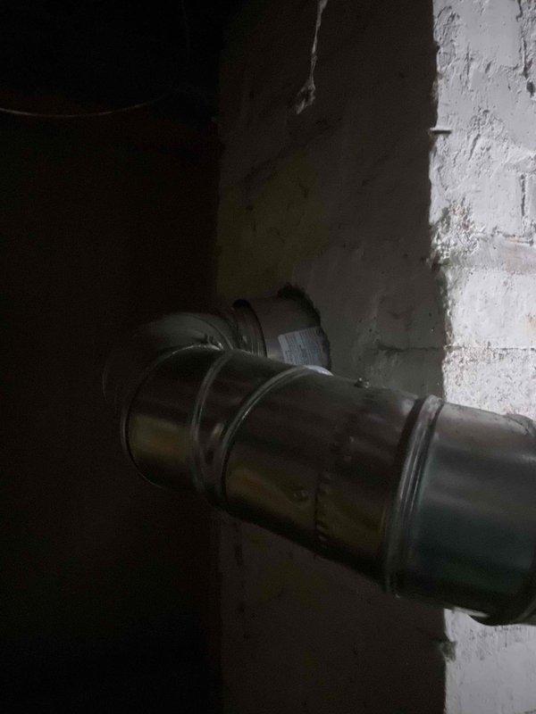 Responded to water heater leak with inconsistent temperature distribution throughout home. Upon arrival, found active water pooling on basement floor beneath unit and confirmed leak at water heater connections. Inspected Honeywell unit over 10 years old, documented water damage to surrounding area, and assessed flex line connections and valve fittings for failure points. Photographed leak source and standing water conditions for documentation purposes.