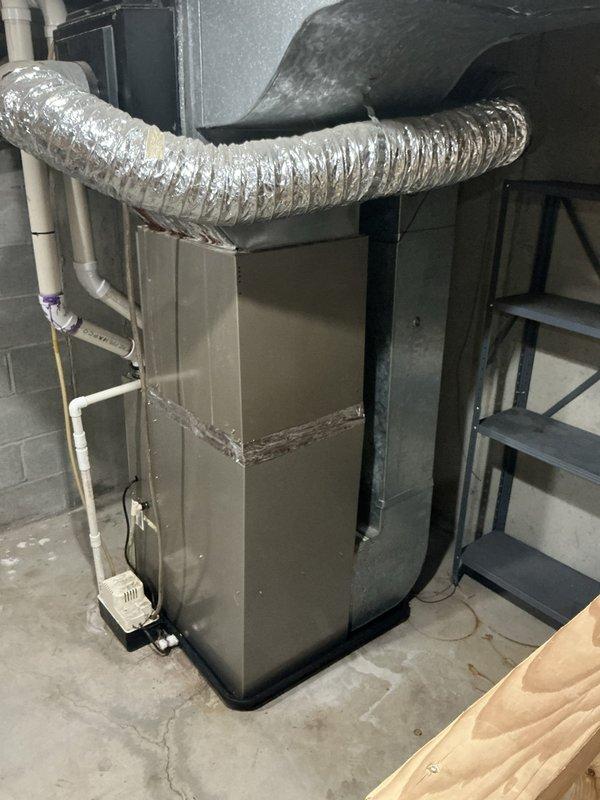 Completed estimate for HVAC system replacement in residential property for club member with 24-year-old ICP equipment due for replacement in 2026. Documented existing furnace/air handler installation in basement utility room, including current ductwork configuration, condensate drain system with PVC piping, and condensate pump setup. Assessment included evaluation of metal ductwork connections, plenum assembly, and overall mechanical room layout to provide accurate replacement specifications and equipment recommendations.