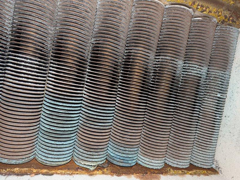Completed annual heating maintenance on residential boiler system. Performed comprehensive tune-up including inspection of heat exchanger, which showed mineral deposits and discoloration indicating exposure to moisture over time. Examined gas valve assembly, noting significant corrosion and deterioration of painted surfaces with rust present on valve body. All components tested and system confirmed operational. No humidifier present on unit as noted. System cleared for continued service with recommendation for monitoring of corroded valve components.