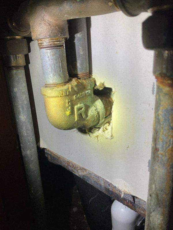 Responded to service call for multiple plumbing issues including plugged drains, severely restricted water flow from faucets due to calcium buildup, and an active leak in the garage with potential source originating from basement area. Inspected bathroom fixtures showing mineral deposits on chrome fittings and tub hardware, as well as corroded brass elbow fitting in utility space exhibiting significant yellow-green corrosion and deterioration at connection points. Documented conditions with photos for estimate preparation and provided assessment of required repairs.
