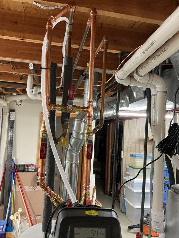 Completed installation of SWS1-45 water softener system in basement utility area. Installation included integration with existing copper supply lines, proper placement of inlet and shut-off valves, and connection to drain system via utility sink. System was pressure tested, programmed for optimal performance, and left fully operational with all components properly secured and labeled.