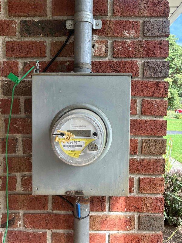 Completed on-site generator installation estimate for residential single-family home. Evaluated existing electrical infrastructure including exterior utility meter mounted on brick wall with digital readout and gray conduit system, as well as interior electrical panel box in basement with dual-column breaker configuration. Assessed electrical service capacity, panel compatibility, and optimal placement for Generac standby generator system. Documented current electrical setup through photographs showing meter base, service entrance conductors, main breaker panel, and available conduit pathways. Reviewed installation requirements including transfer switch placement, gas line accessibility, and proper clearances for generator pad location. Property features long driveway access located near interstate with landmark identification for future installation crew coordination. Provided comprehensive quote covering generator unit specifications, automatic transfer switch, electrical connections