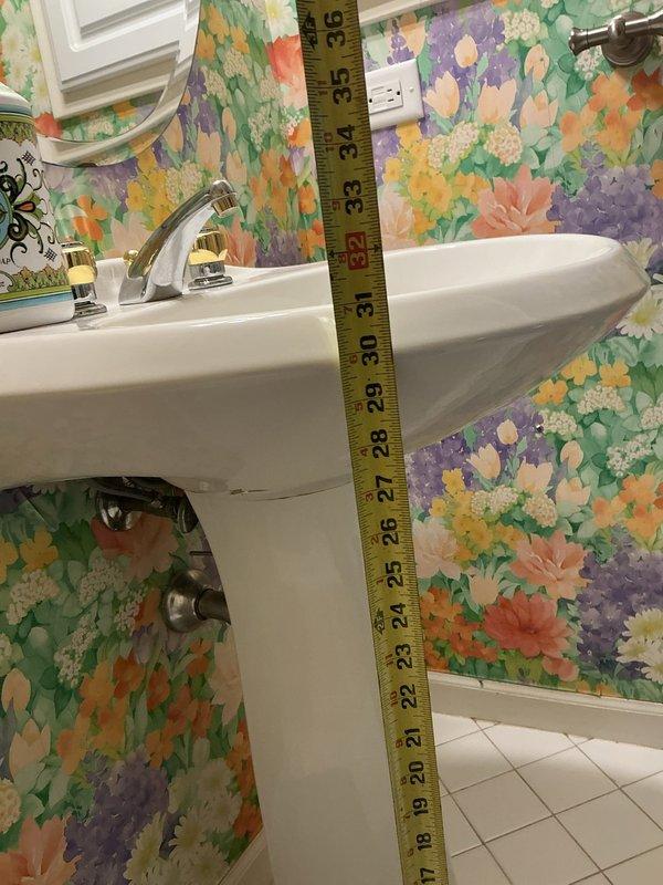 Responded to service call for loose toilet in master bathroom and pedestal sink replacement consultation. Secured toilet to floor by tightening closet bolts and checking wax ring seal for proper installation. Verified toilet stability and tested for any rocking or movement. Assessed existing pedestal sink for replacement, taking measurements of current installation height and discussing fixture options with customer. Documented sink dimensions and plumbing configuration with photographs for future replacement planning. All plumbing connections inspected and found to be functioning properly with no leaks detected.