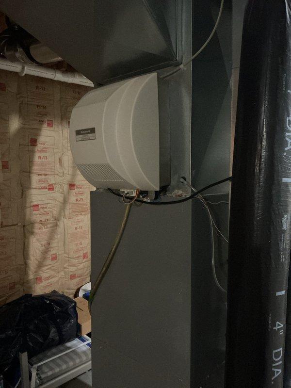 Completed comprehensive furnace super tune-up on a 15-year-old heating system. Performed full inspection of HVAC equipment, including humidifier unit mounted on ductwork with proper water supply and electrical connections verified, and confirmed all components are functioning within normal parameters.