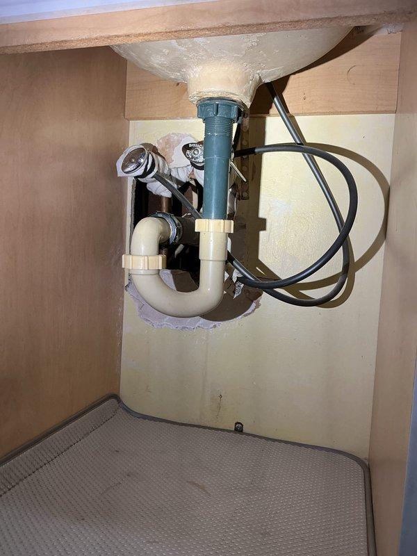 Conducted comprehensive plumbing assessment for multiple fixture issues including inconsistent leaks at kitchen sink and blocked hot water line in bathroom. Inspected existing plumbing configurations under sinks, evaluated P-trap assemblies, shut-off valves on hot and cold water supply lines at kitchen and bathroom locations, and assessed bathtub fixtures requiring handle and spout replacement. Documented current conditions of drain assemblies, supply line connections, and water heater shut-off valve. Photographed under-sink plumbing showing existing P-trap configurations, shut-off valve conditions, and supply line routing at both locations. Provided detailed material and labor time estimates for replacement of kitchen and bathroom faucets, P-trap assemblies at both locations, shut-off valves on all hot and cold supply lines, water heater supply line shut-off valve, and complete bathtub handle and spout assembly replacement to resolve leaking and blockage issues.