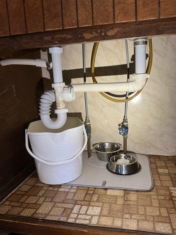 Conducted comprehensive plumbing assessment for multiple fixture issues including inconsistent leaks at kitchen sink and blocked hot water line in bathroom. Inspected existing plumbing configurations under sinks, evaluated P-trap assemblies, shut-off valves on hot and cold water supply lines at kitchen and bathroom locations, and assessed bathtub fixtures requiring handle and spout replacement. Documented current conditions of drain assemblies, supply line connections, and water heater shut-off valve. Photographed under-sink plumbing showing existing P-trap configurations, shut-off valve conditions, and supply line routing at both locations. Provided detailed material and labor time estimates for replacement of kitchen and bathroom faucets, P-trap assemblies at both locations, shut-off valves on all hot and cold supply lines, water heater supply line shut-off valve, and complete bathtub handle and spout assembly replacement to resolve leaking and blockage issues.