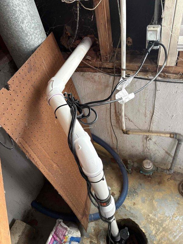 Replaced existing sump pump system with new unit, including installation of new discharge piping routed through basement wall to exterior. Secured all PVC drainage lines with proper mounting straps and verified proper pitch for optimal water flow and system operation.