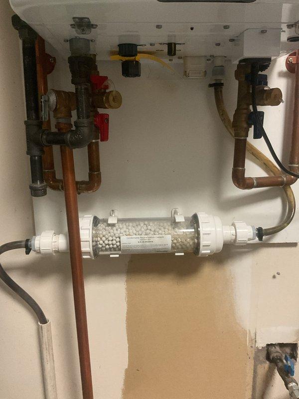 Completed filter replacement on 5-year-old Navien tankless water heater system. Removed and replaced sediment filter housing containing ceramic filtration media, ensuring proper water flow and system protection. Verified all connections, tested system operation, and confirmed no leaks at filter housing or associated copper piping connections.