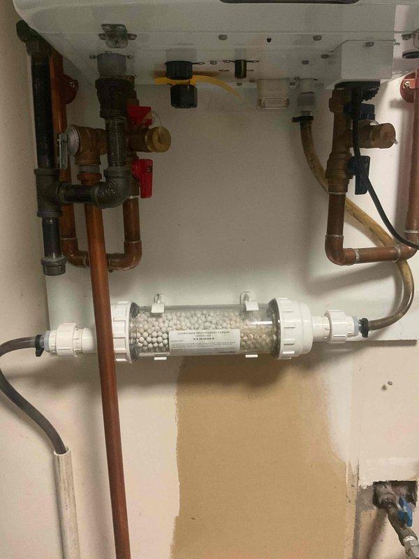 Completed filter replacement on 5-year-old Navien tankless water heater system. Removed and replaced sediment filter housing containing ceramic filtration media, ensuring proper water flow and system protection. Verified all connections, tested system operation, and confirmed no leaks at filter housing or associated copper piping connections.