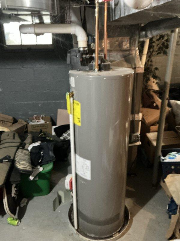 Provided estimate for replacement of existing 40-gallon gas water heater with power vent unit in single family home basement. Current water heater manufactured in November 2019 is operational with no reported issues, leaks, or failures. Documented existing installation including PVC power vent piping and copper supply connections for accurate replacement proposal.