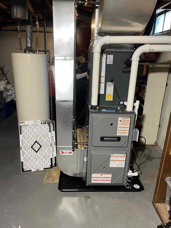Completed full HVAC system installation including new furnace and air conditioning condensing unit. Installed furnace in basement utility area with proper PVC venting, air filter access compartment, and drip pan placement on concrete floor. Mounted outdoor AC condensing unit on concrete pad against exterior wall with appropriate electrical disconnect and refrigerant line routing through wall penetration. All equipment secured, connected, and operational per manufacturer specifications.