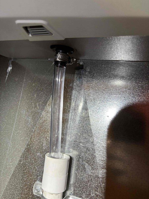 Completed annual heating maintenance on 6-year-old EnergiAir system with humidifier. Inspected drainage assembly and condensate connections, verifying proper tube routing and clamp security beneath unit. Cleaned and examined humidifier drain pan, checking for proper drainage and removing any debris to ensure optimal operation throughout heating season.