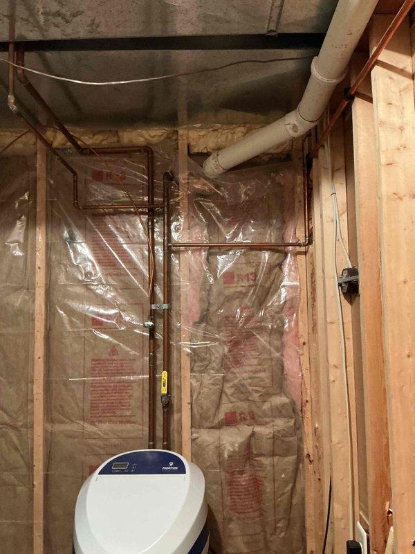 Conducted tankless water heater estimate for customer inquiring about current promotional offering. Assessed existing installation consisting of Rheem Marathon electric water heater in unfinished basement utility area with exposed framing, copper supply lines, and adjacent HVAC system. Documented current equipment configuration, plumbing connections, and available space for potential tankless unit installation, capturing details of water treatment system, electrical access, and venting requirements for conversion feasibility.